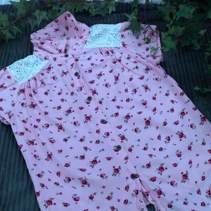 A pink shirt with roses and lace